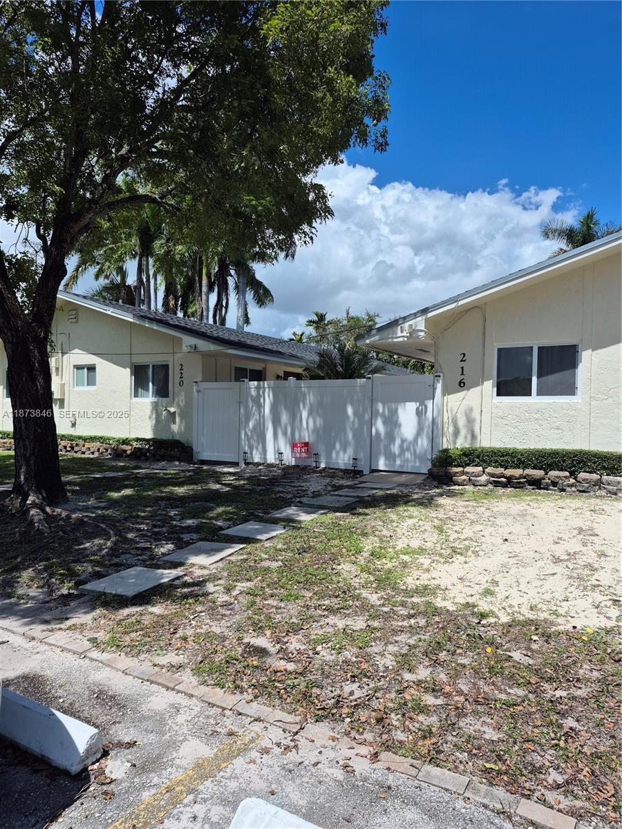 216 Southwest 9th Street, Unit 2 Hallandale Beach, FL 33009 - Photo 14 of 19 a view of a house with backyard and sitting area