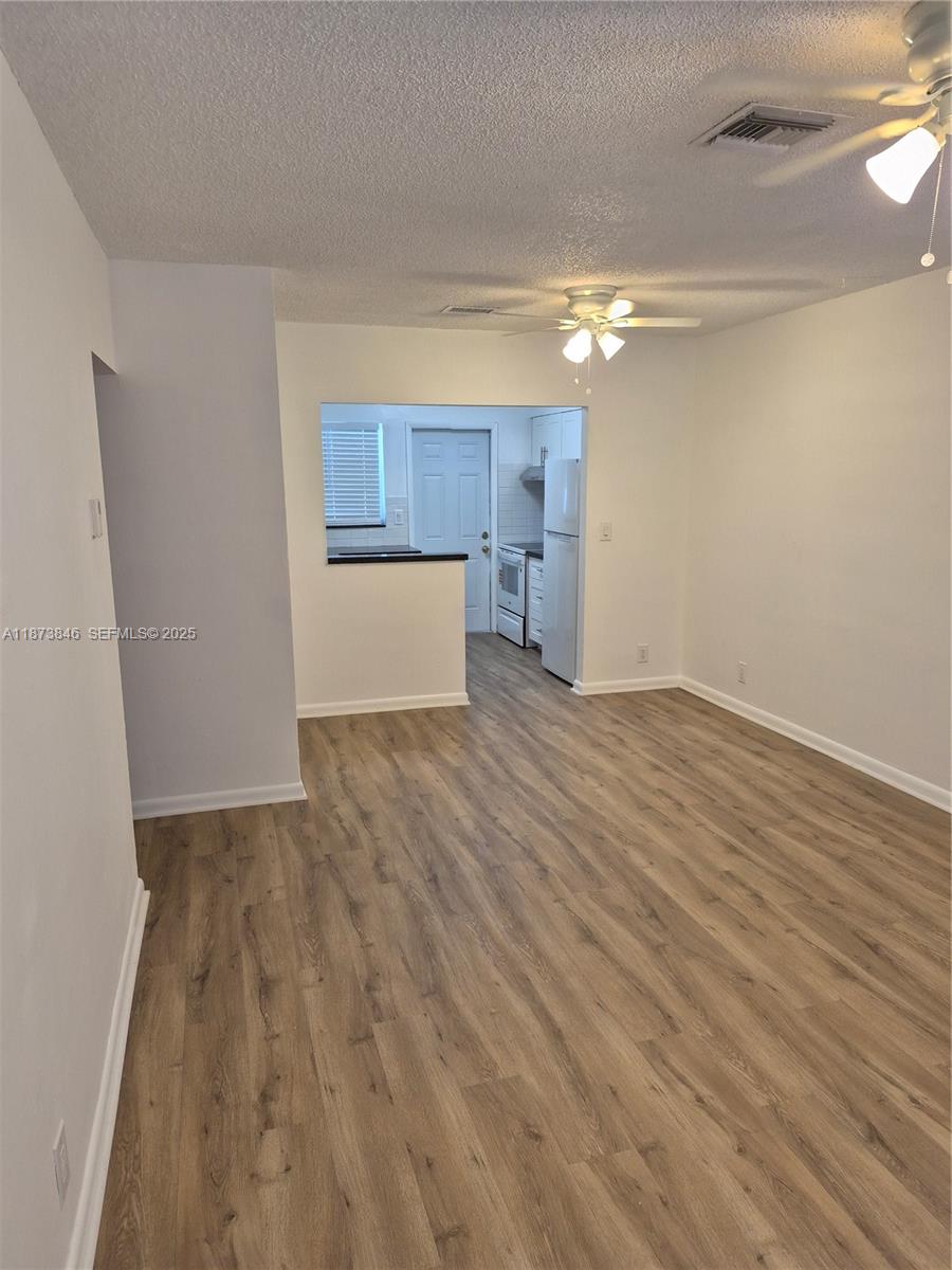 216 Southwest 9th Street, Unit 2 Hallandale Beach, FL 33009 - Photo 2 of 19 a view of empty room with wooden floor