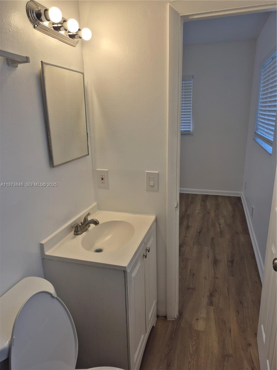 216 Southwest 9th Street, Unit 2 Hallandale Beach, FL 33009 - Photo 5 of 19 a bathroom with a sink mirror and vanity