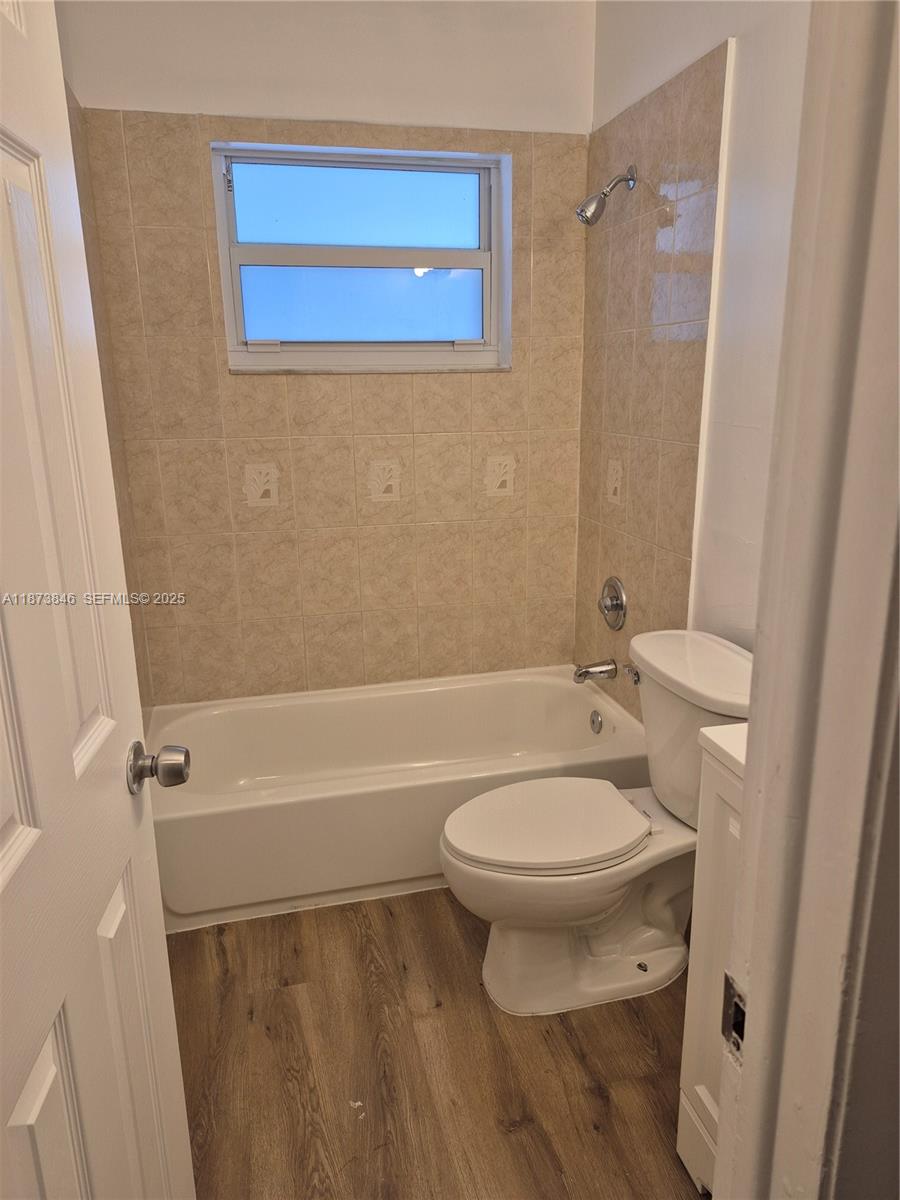 216 Southwest 9th Street, Unit 2 Hallandale Beach, FL 33009 - Photo 6 of 19 a white toilet sitting next to a bath tub