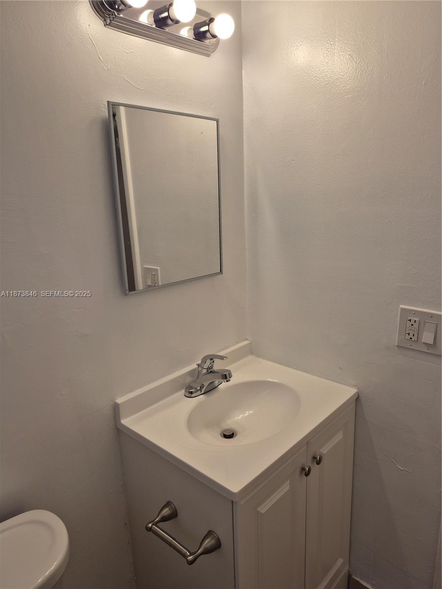 216 Southwest 9th Street, Unit 2 Hallandale Beach, FL 33009 - Photo 7 of 19 a bathroom with a sink and a mirror