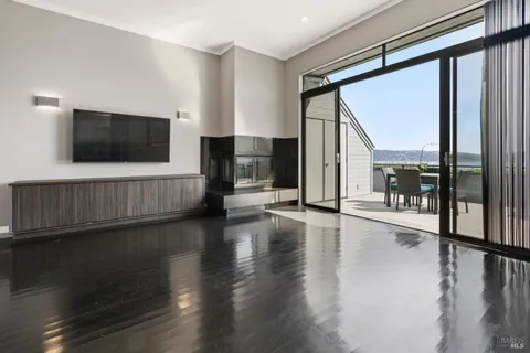 a view of a living room with hardwood floor and a window