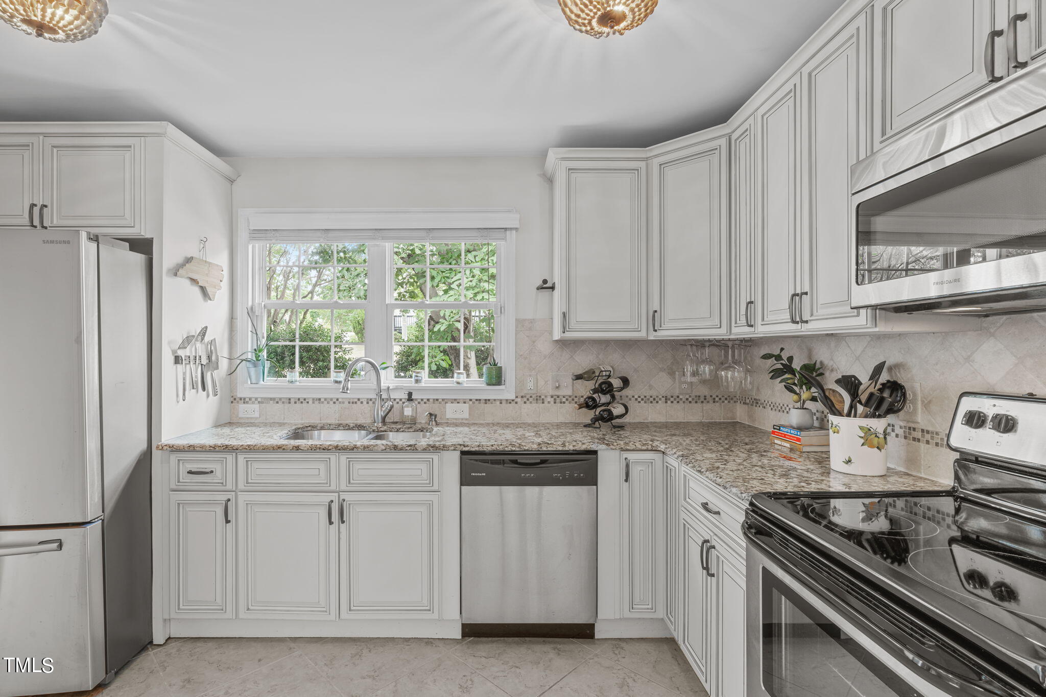 515 Freeman Street Raleigh, NC 27601 - Photo 17 of 44 a kitchen with cabinets appliances a sink and a window