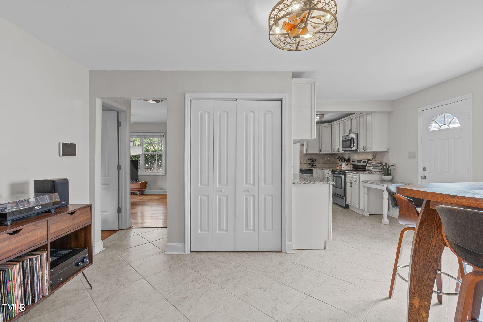 515 Freeman Street Raleigh, NC 27601 - Photo 24 of 44 a kitchen with stainless steel appliances a stove top oven a sink a dining table and chairs