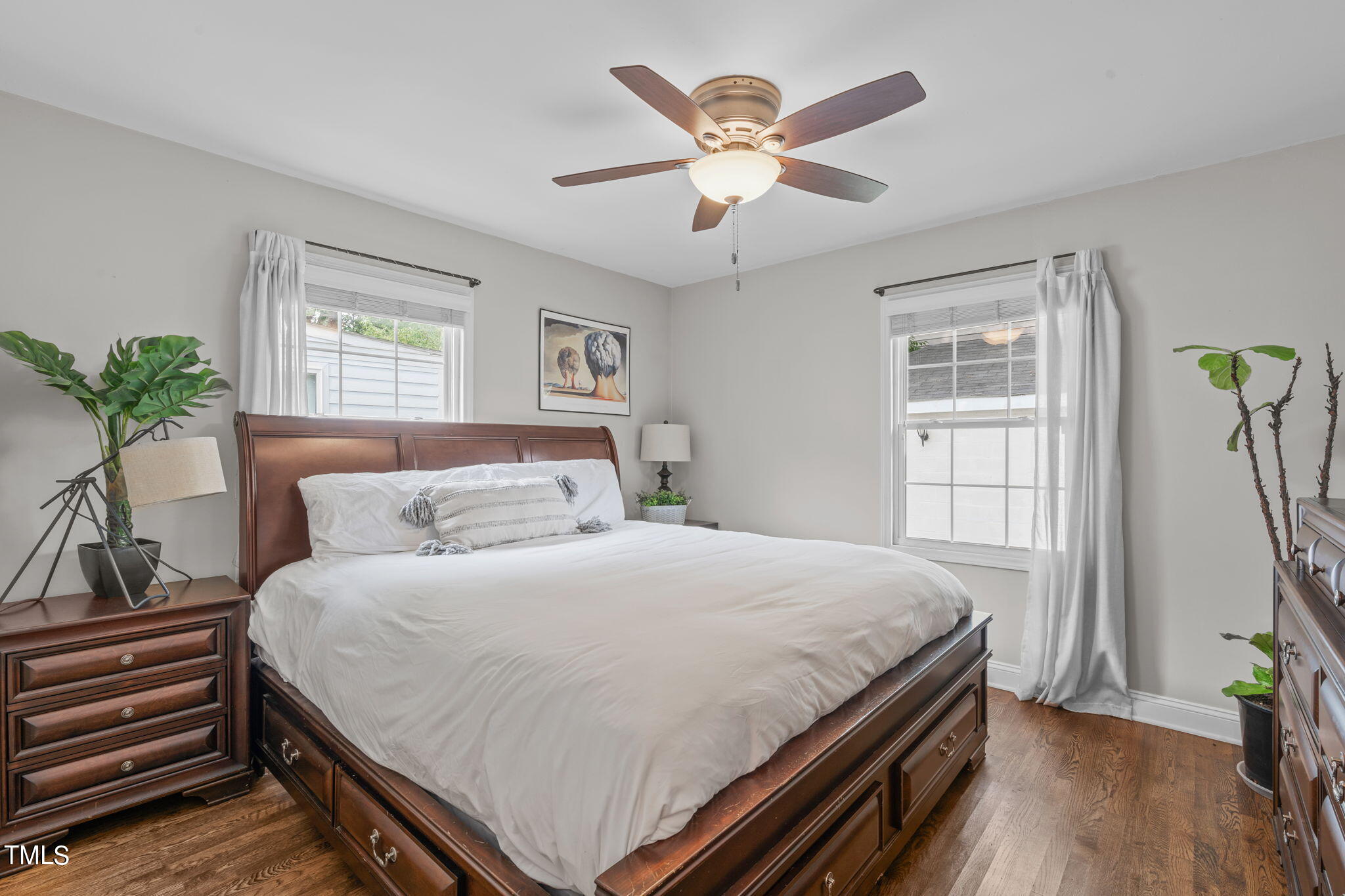 515 Freeman Street Raleigh, NC 27601 - Photo 27 of 44 a bedroom with a large bed and a chandelier