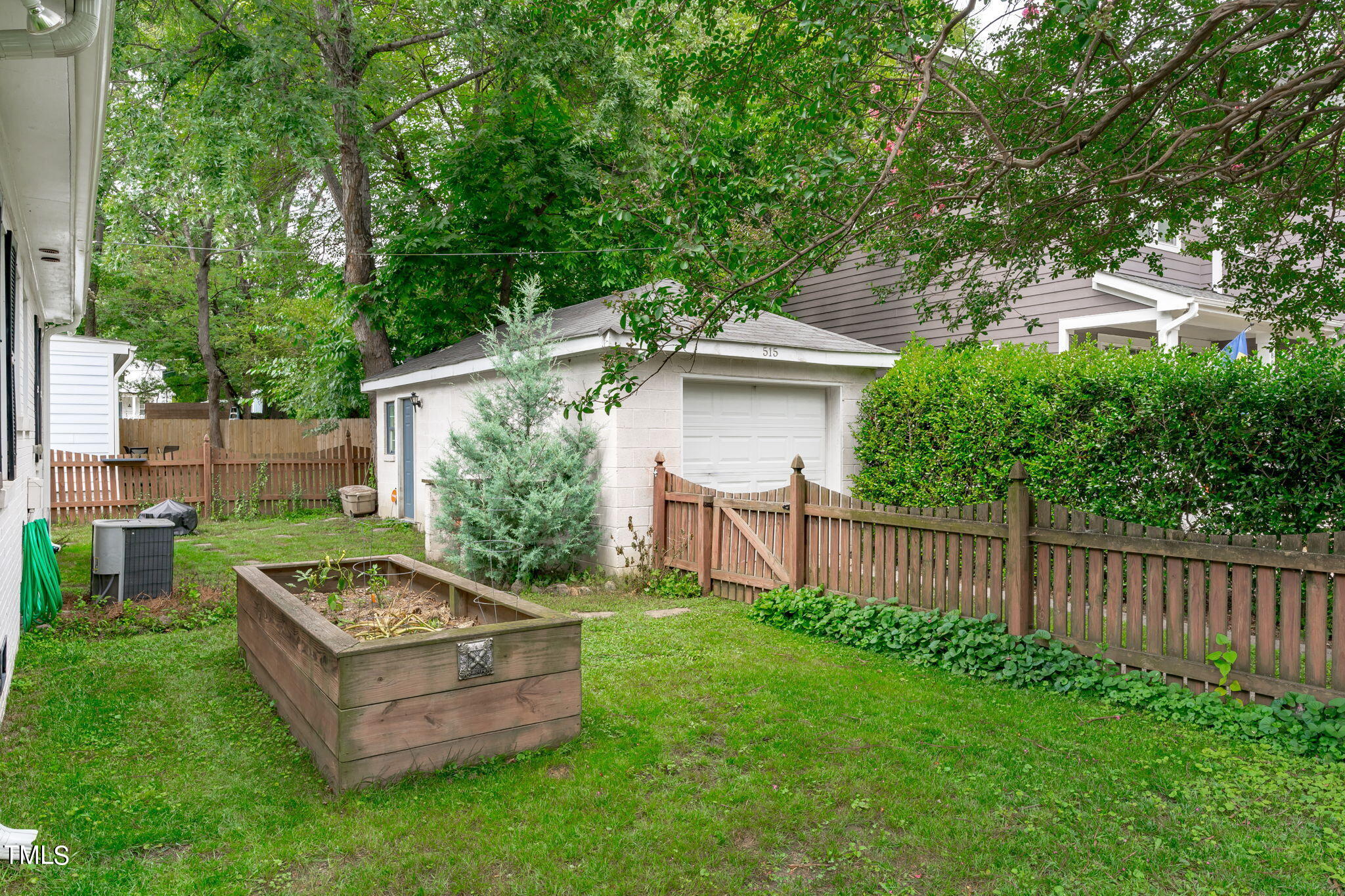 515 Freeman Street Raleigh, NC 27601 - Photo 36 of 44 a view of a small house with a small yard and wooden fence