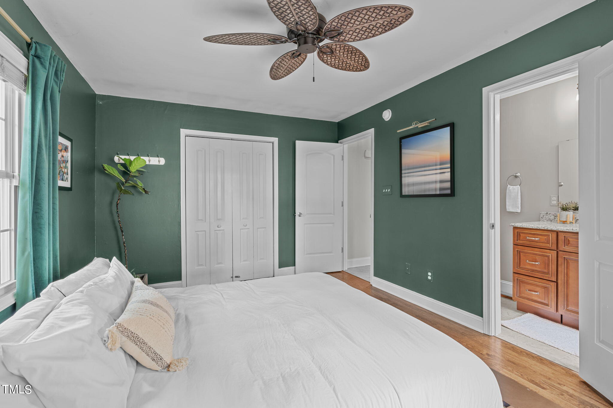 515 Freeman Street Raleigh, NC 27601 - Photo 8 of 44 a bedroom with a bed and a chandelier