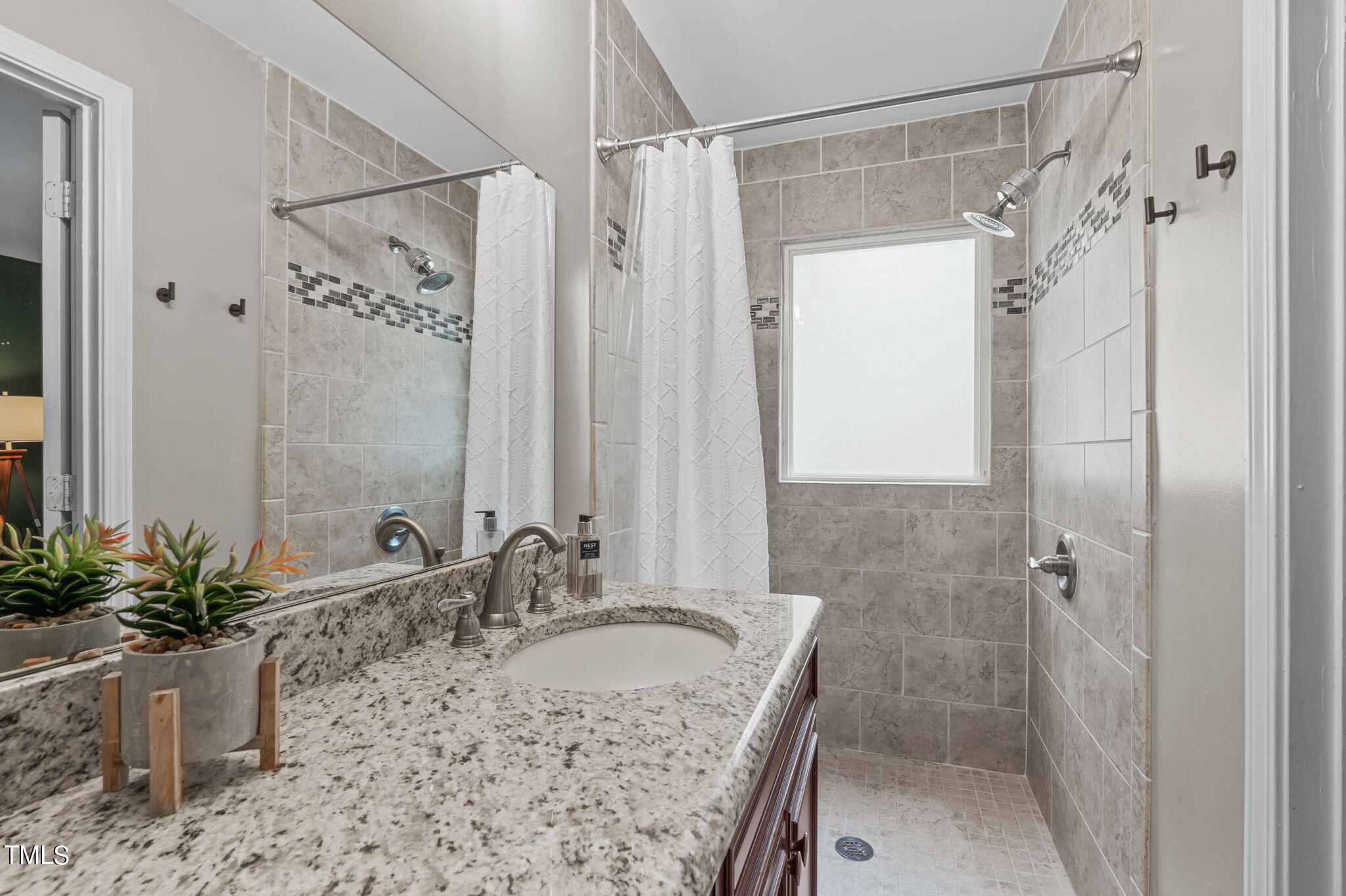 515 Freeman Street Raleigh, NC 27601 - Photo 9 of 44 a bathroom with a tub shower sink and mirror