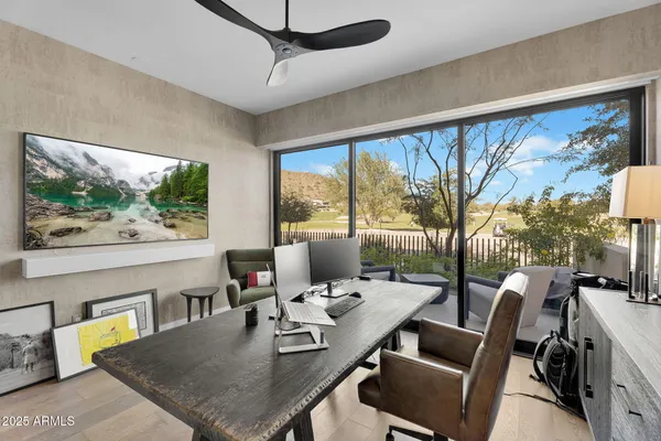 a view of a dining room with furniture large windows and wooden floor