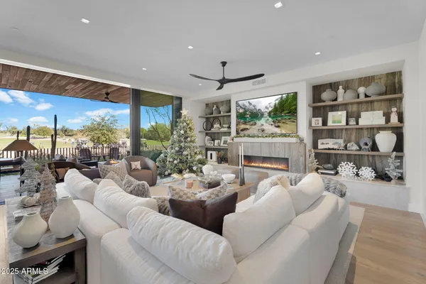 a living room with furniture large window and flat screen tv