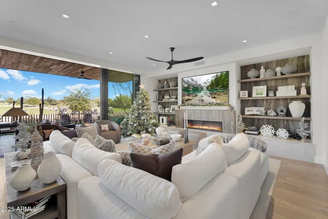 a living room with furniture large window and flat screen tv