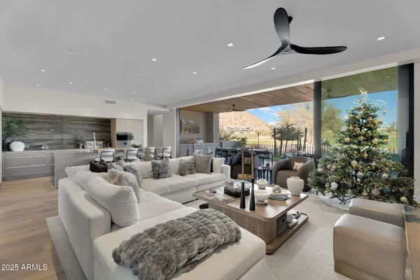 a living room with furniture potted plant and a large window