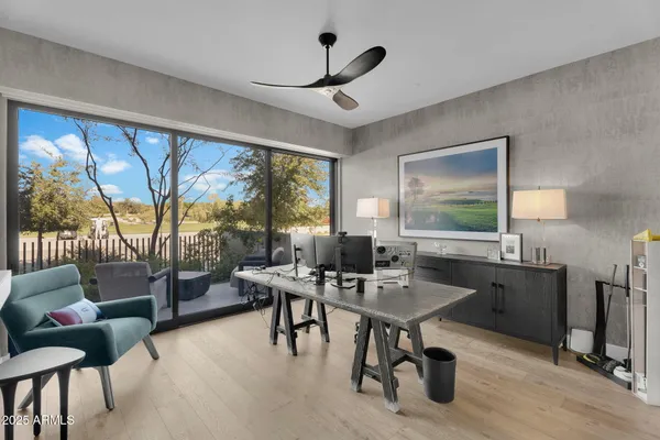 a workspace with furniture and a large window