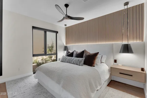 a bedroom with a large bed and a window