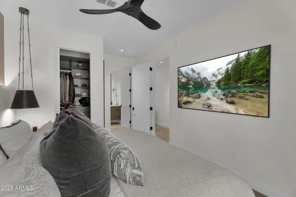 a bed room with a bed and a painting on the wall