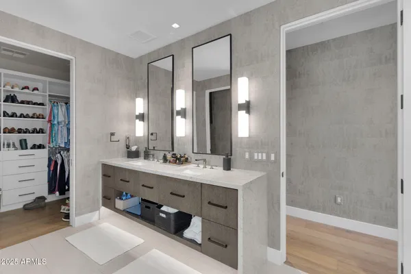 a bathroom with a double vanity sink a mirror and a shower