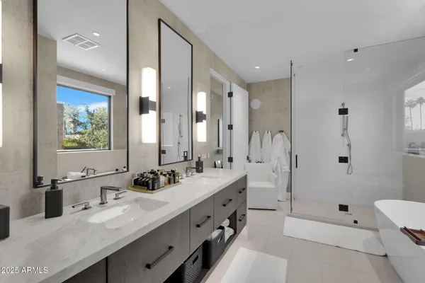 a bathroom with a double vanity sink mirror double and shower