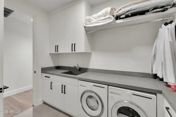 a kitchen with granite countertop a sink a stove and cabinets
