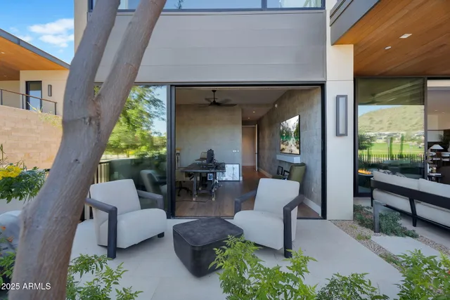 a view of a patio with dining table and chairs