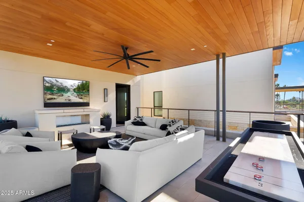 a living room with furniture floor to ceiling window and a table