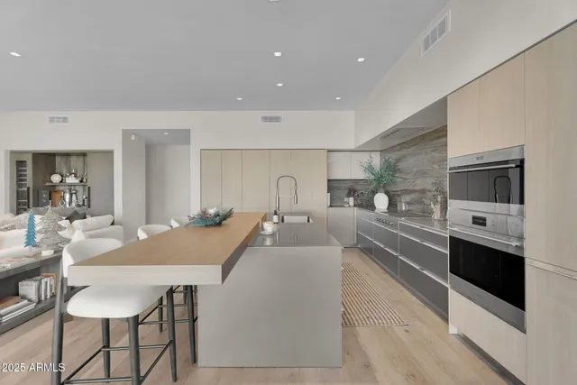 a kitchen with stainless steel appliances granite countertop a stove a sink and a refrigerator