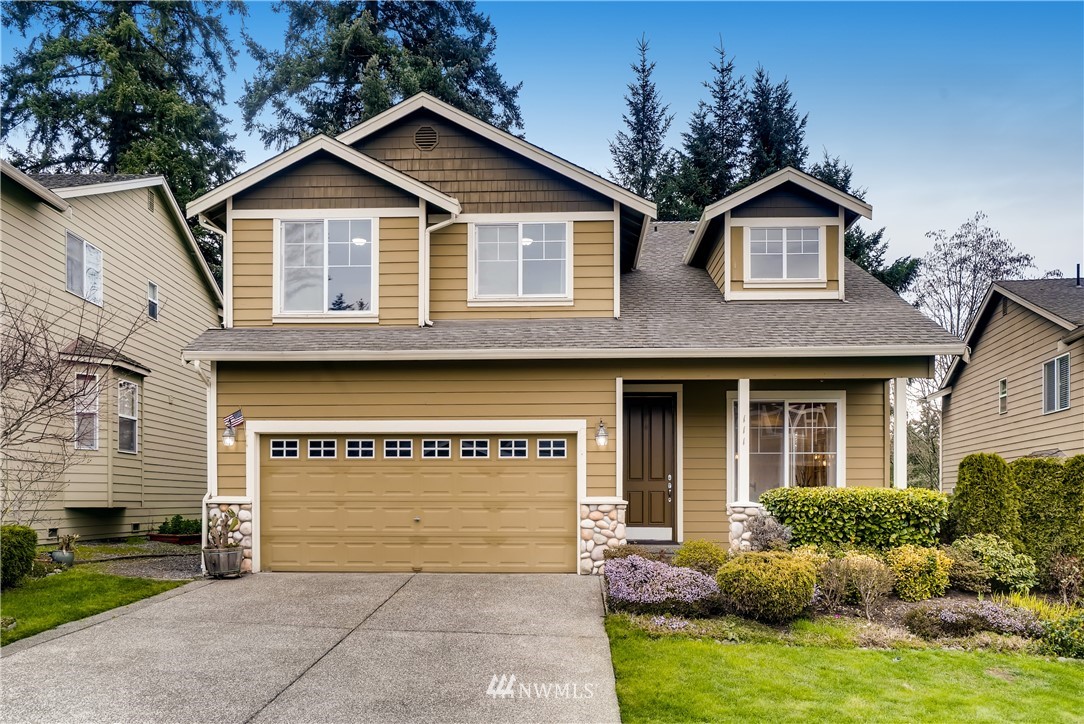 111 203rd Street Southeast Bothell, WA 98012 - Photo 2 of 31 a front view of a house with a yard and garage