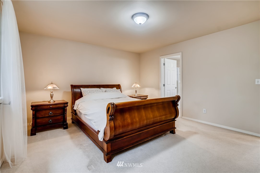 111 203rd Street Southeast Bothell, WA 98012 - Photo 18 of 31 a bed sitting in a bedroom next to a lamp