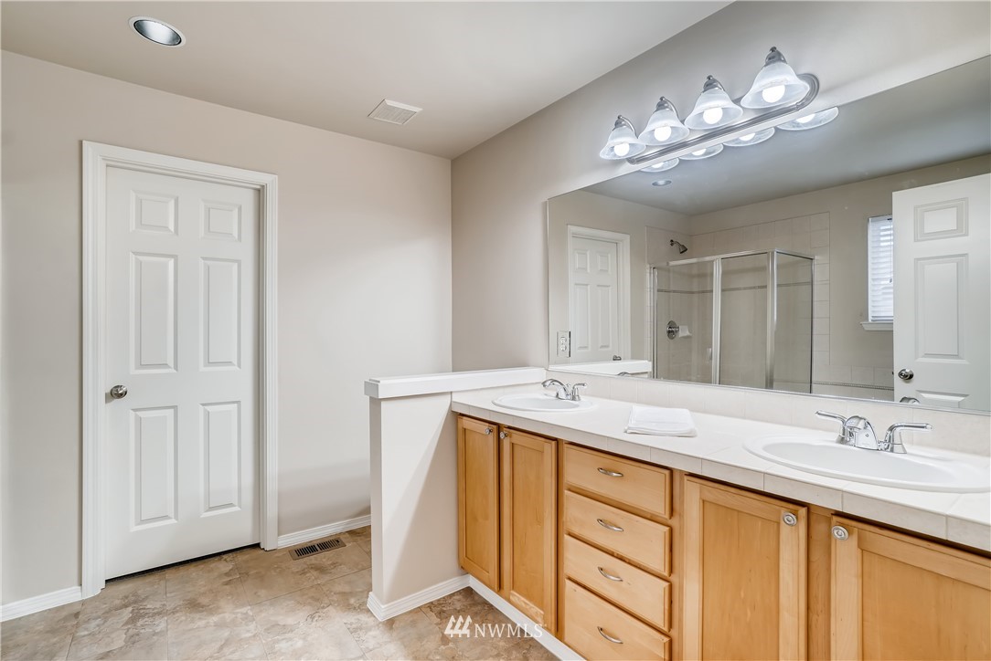 111 203rd Street Southeast Bothell, WA 98012 - Photo 19 of 31 a bathroom with a double vanity sink and a mirror
