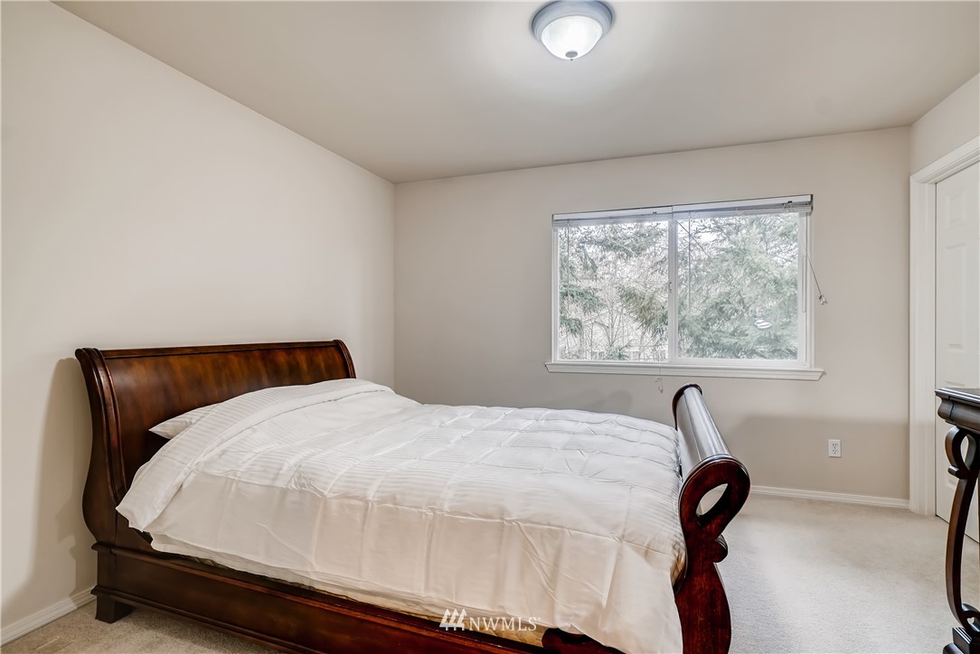 111 203rd Street Southeast Bothell, WA 98012 - Photo 21 of 31 a bed sitting in a bedroom next to a window