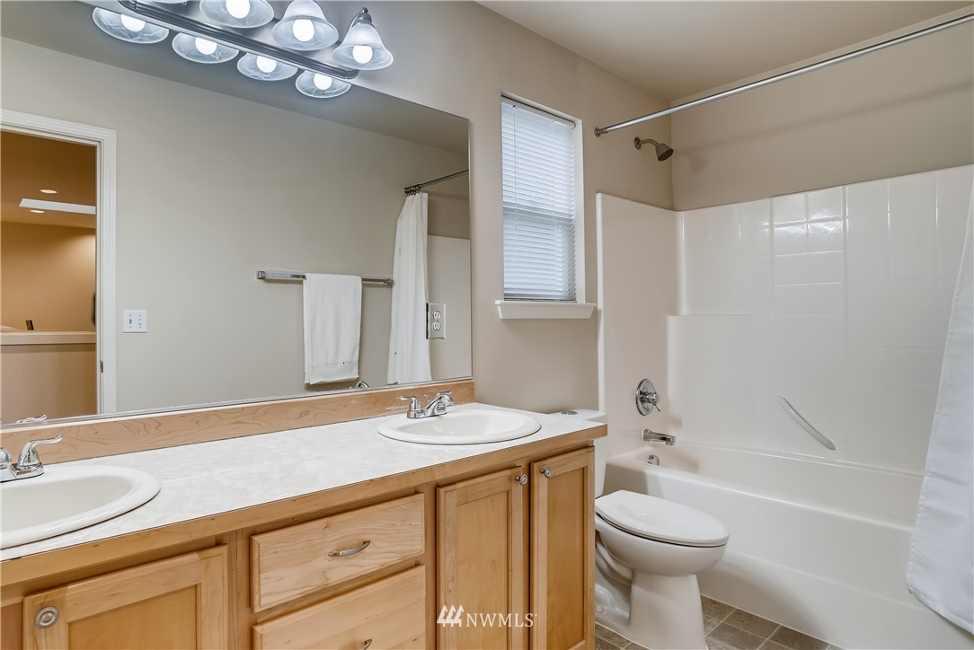 111 203rd Street Southeast Bothell, WA 98012 - Photo 22 of 31 a bathroom with a sink a toilet a mirror a vanity and bathtub