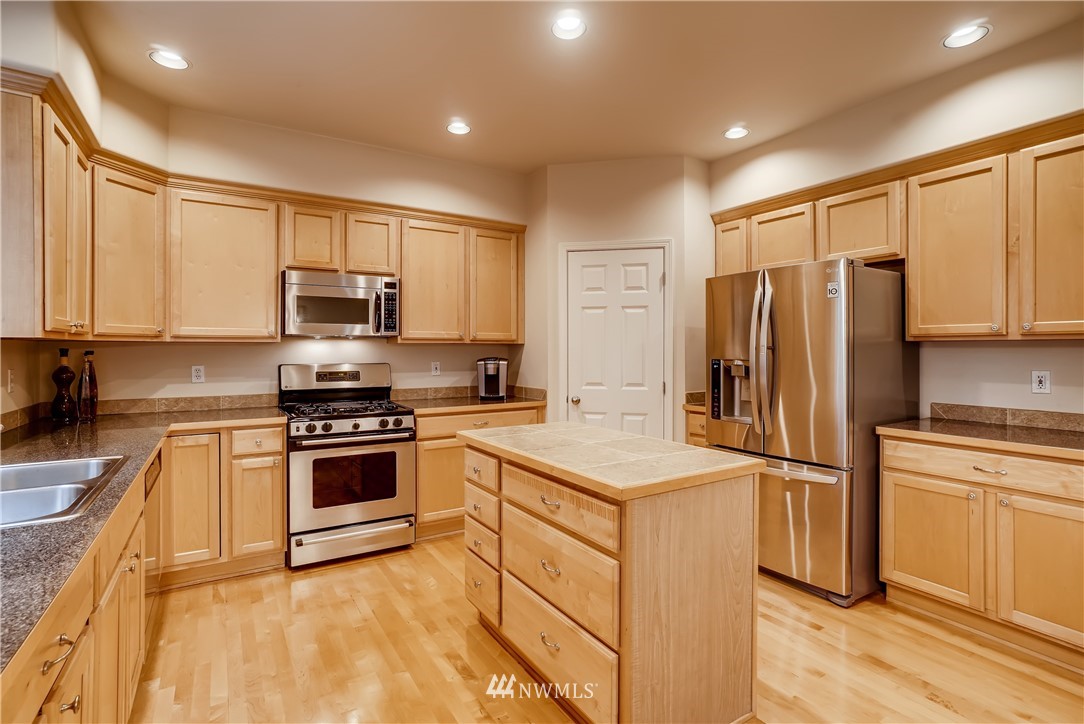 111 203rd Street Southeast Bothell, WA 98012 - Photo 9 of 31 a kitchen with cabinets stainless steel appliances and a counter space