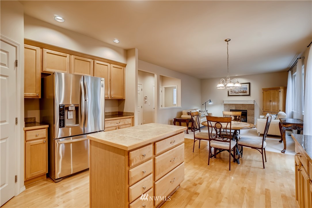 111 203rd Street Southeast Bothell, WA 98012 - Photo 10 of 31 a kitchen with stainless steel appliances granite countertop sink refrigerator dining table and chairs