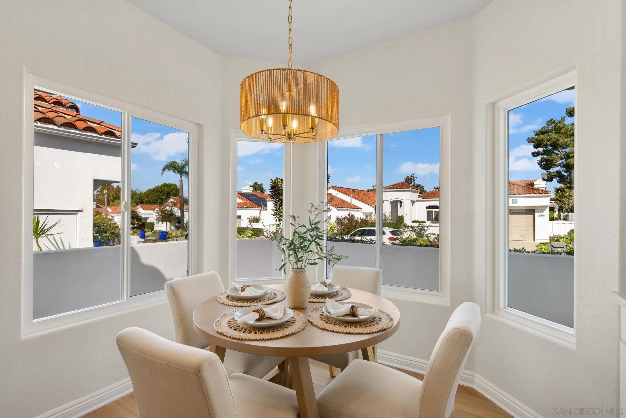 4957 Lamia Way Oceanside, CA 92056 - Photo 12 of 31 a view of a dining room with furniture wooden floor and a chandelier