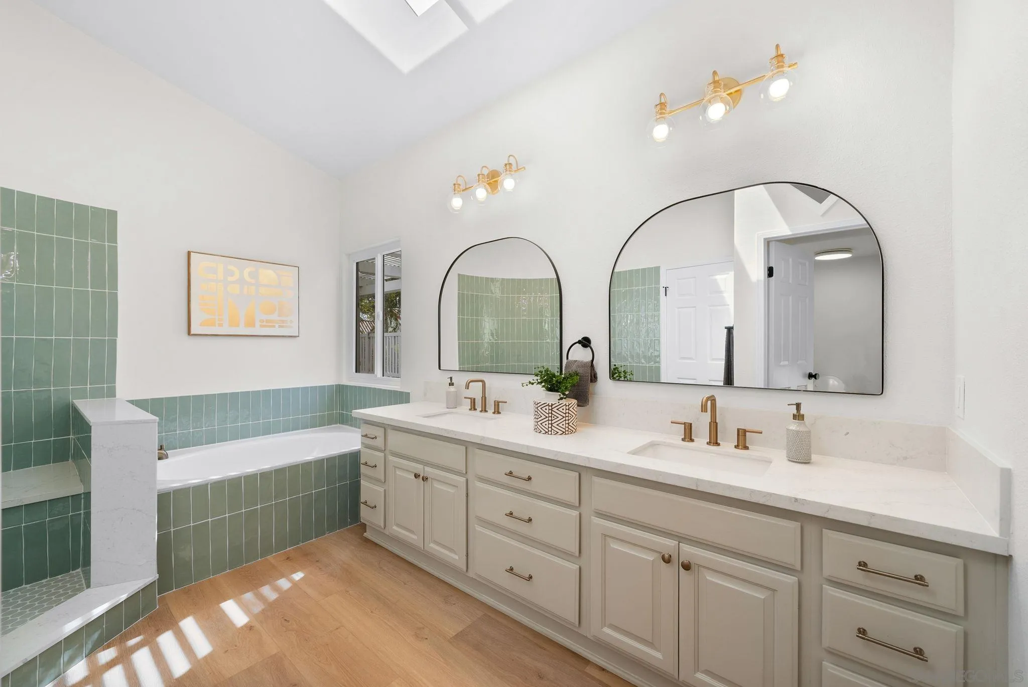 4957 Lamia Way Oceanside, CA 92056 - Photo 20 of 31 a spacious bathroom with a double vanity sink a mirror a bathtub and