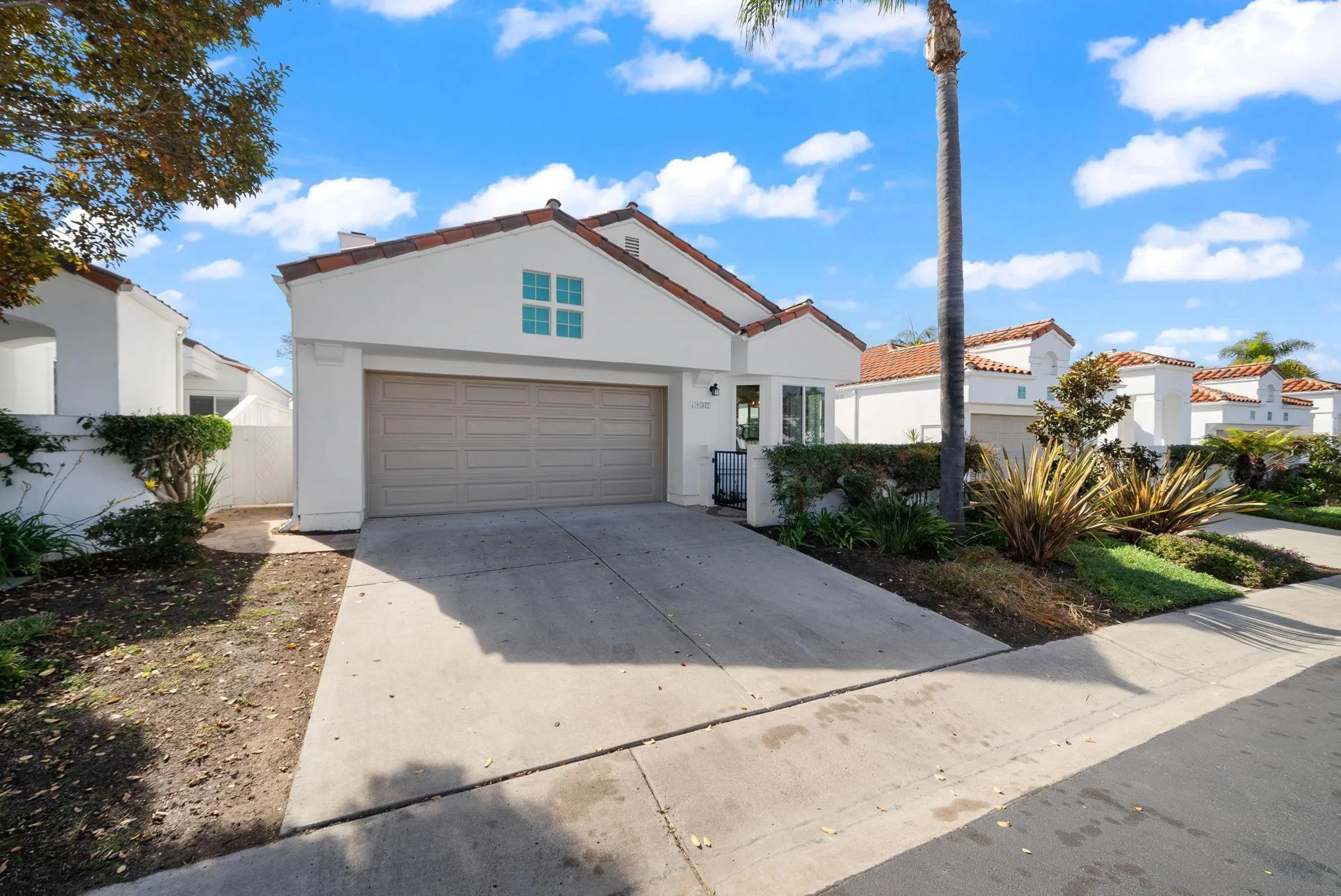 4957 Lamia Way Oceanside, CA 92056 - Photo 25 of 31 a front view of a house with a yard and garage