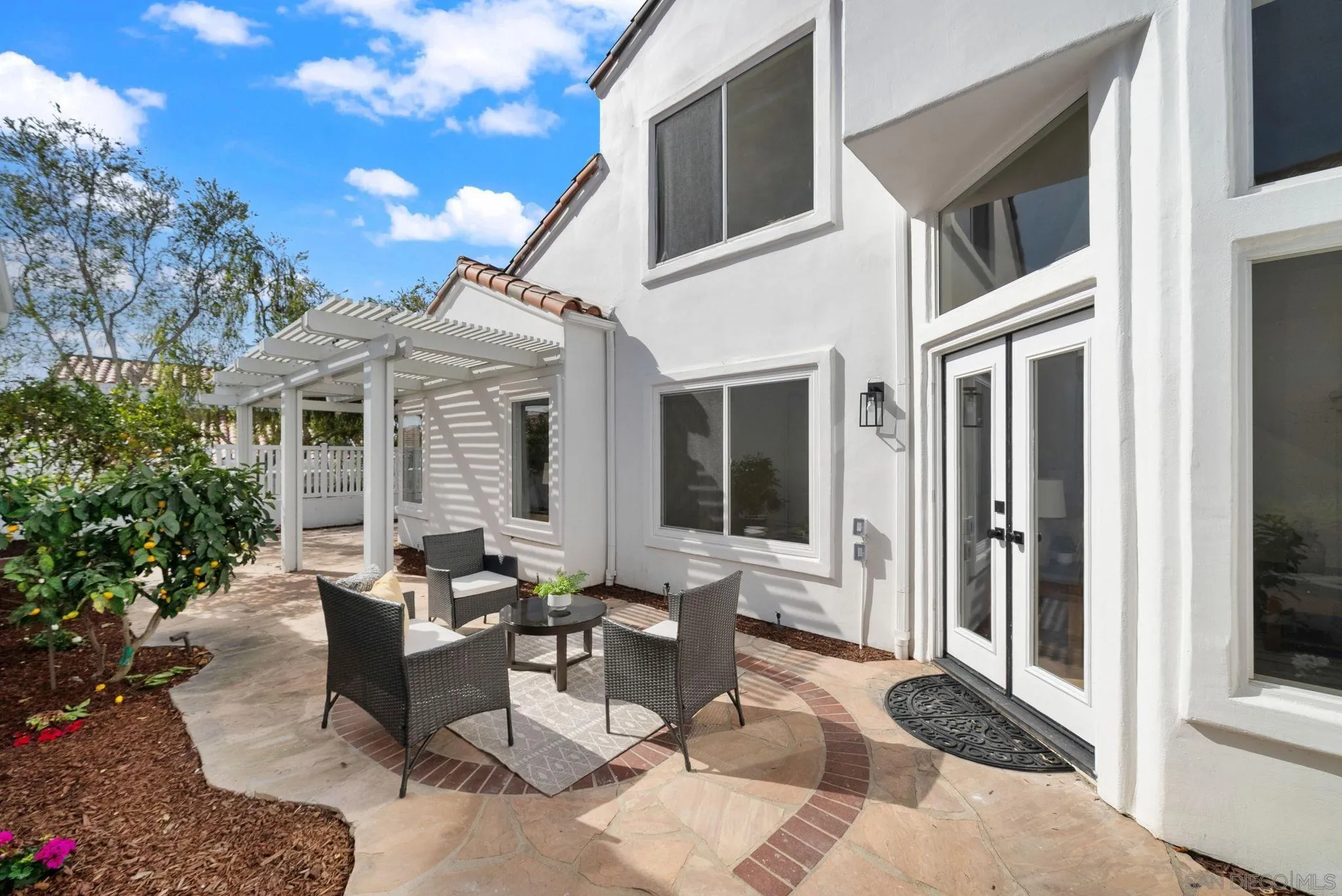 4957 Lamia Way Oceanside, CA 92056 - Photo 27 of 31 a view of a house with backyard sitting area and porch