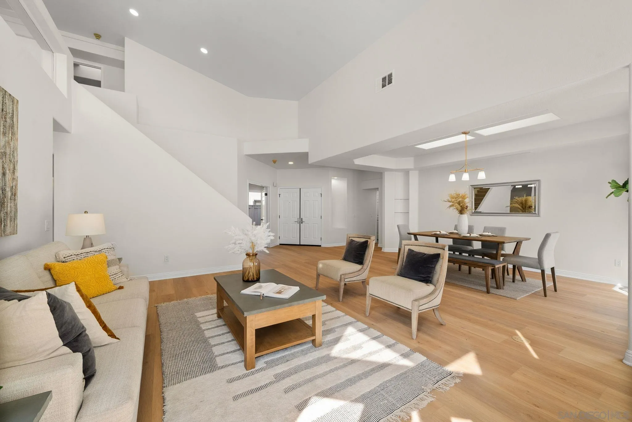 4957 Lamia Way Oceanside, CA 92056 - Photo 3 of 31 a living room with furniture and a dining table with wooden floor