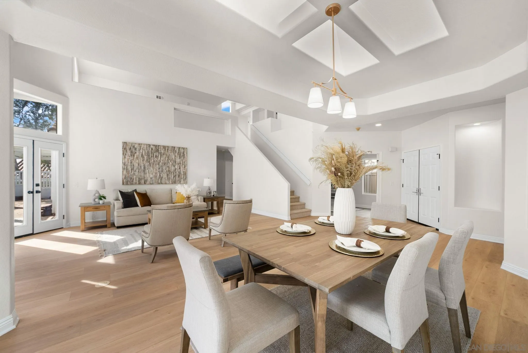 4957 Lamia Way Oceanside, CA 92056 - Photo 8 of 31 a view of a dining room and livingroom with furniture wooden floor a chandelier
