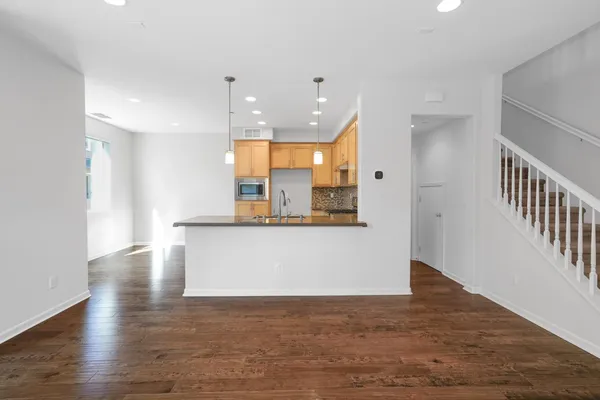 a view of kitchen and hall with wooden floor