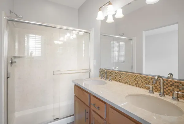 a bathroom with a double vanity sink and a mirror