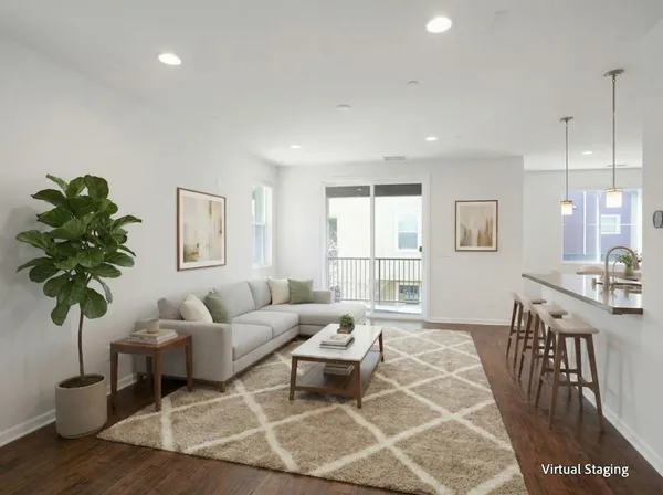 a living room with furniture a potted plant and a table