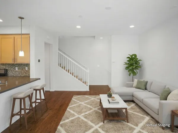 a living room with furniture and wooden floor