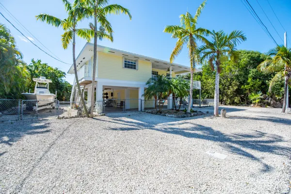 a couple of palm trees in front of house