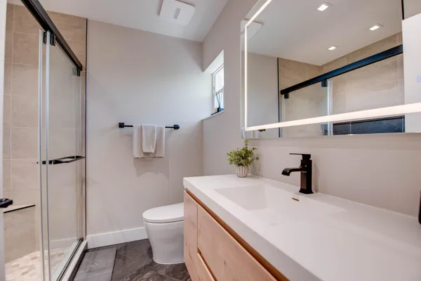 a bathroom with a glass shower door