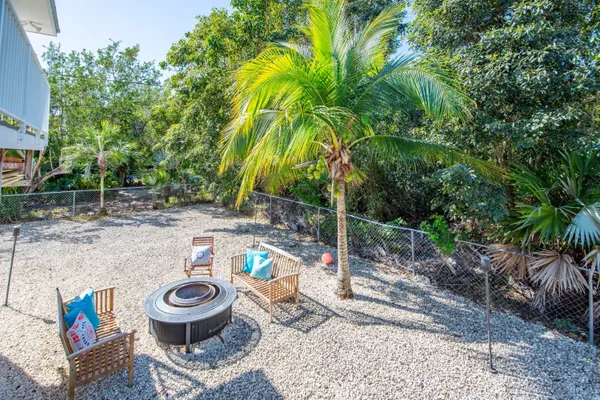 a view of a backyard with plants and a patio