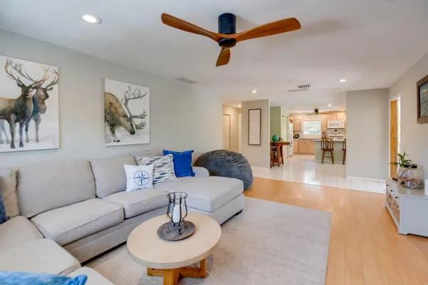 a living room with furniture and kitchen view