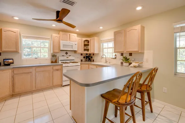 a kitchen with a sink cabinets and window
