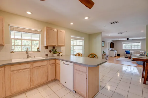 a very nice looking kitchen with lots of counter space and windows