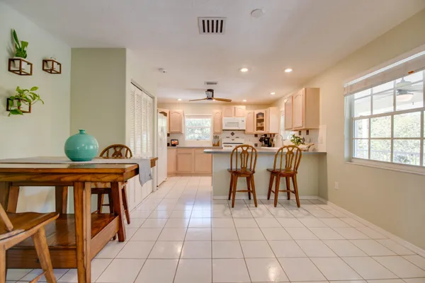 a view of a dining room with furniture and a potted plant
