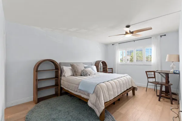 a bedroom with a bed and a table in it